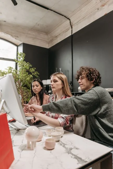 A clean and modern workspace featuring a laptop, tablet, smartphone, and monitor. Ideal for remote work and tech setups.